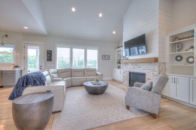 2117 Southern Preserve Ln, Franklin, TN 37064 - living area with high vaulted ceiling, light wood-type flooring, healthy amount of natural light, a fireplace, and recessed lighting