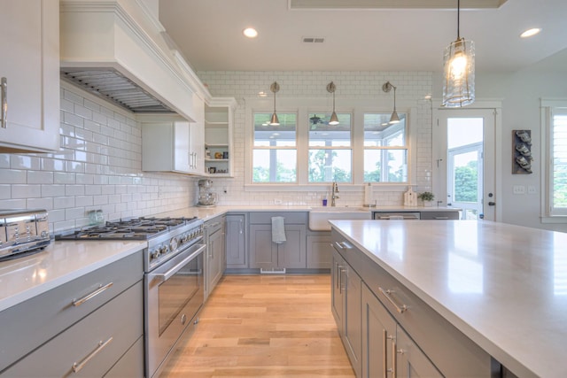 2117 Southern Preserve Ln, Franklin, TN 37064 - kitchen with high end range, gray cabinetry, custom range hood, light countertops, and recessed lighting