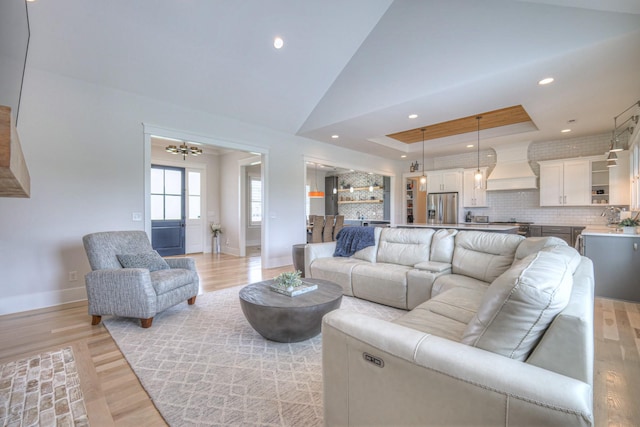 2117 Southern Preserve Ln, Franklin, TN 37064 - living room featuring light wood-style floors, recessed lighting, a raised ceiling, and a chandelier