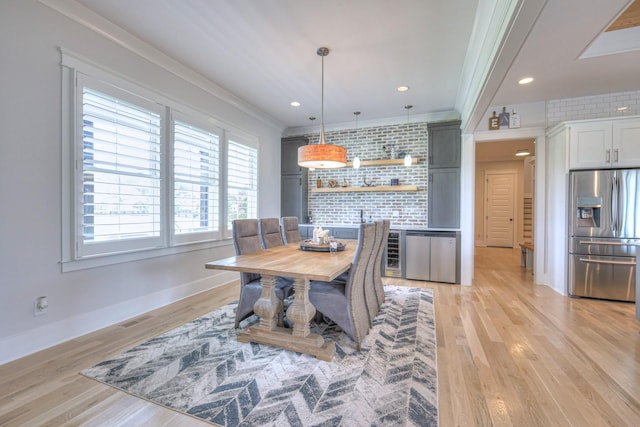 2117 Southern Preserve Ln, Franklin, TN 37064 - dining room featuring ornamental molding, plenty of natural light, light wood-style flooring, and wine cooler