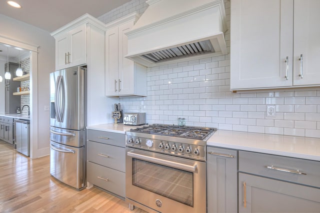 2117 Southern Preserve Ln, Franklin, TN 37064 - kitchen with appliances with stainless steel finishes, custom range hood, gray cabinets, light wood finished floors, and recessed lighting