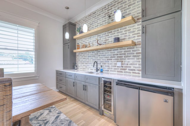 2117 Southern Preserve Ln, Franklin, TN 37064 - indoor wet bar featuring beverage cooler, refrigerator, light wood-style flooring, ornamental molding, and hanging light fixtures