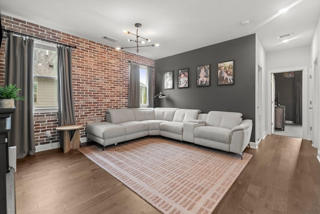 2122 Notchleaf Rd, Antioch, TN 37013 - living area featuring brick wall, healthy amount of natural light, wood finished floors, and baseboards