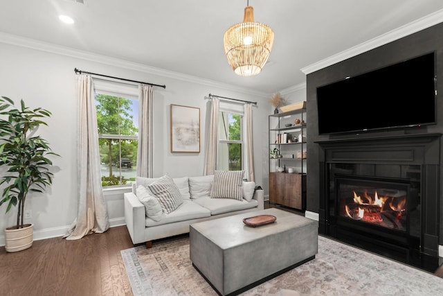 2122 Notchleaf Rd, Antioch, TN 37013 - living area featuring crown molding, wood finished floors, a glass covered fireplace, baseboards, and a chandelier