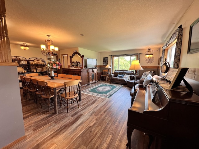 4250 Standing Rock Rd, Jamestown, TN 38556 - dining space featuring wood finished floors, a chandelier, a textured ceiling, and wainscoting