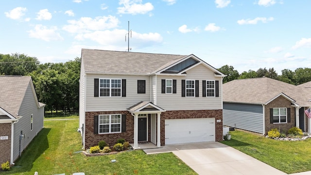 5073 Hunters Village Dr, Lebanon, TN 37087 - view of front of home featuring brick siding, driveway, a front yard, and an attached garage