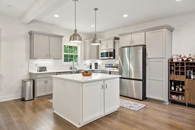 3650 Riggins Rd, Cumberland Furnace, TN 37051 - kitchen with stainless steel appliances, gray cabinetry, decorative backsplash, wood finished floors, and light countertops