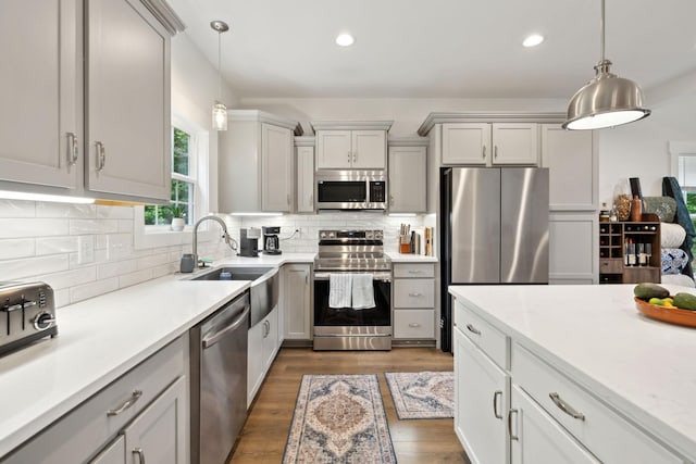 3650 Riggins Rd, Cumberland Furnace, TN 37051 - kitchen with stainless steel appliances, a sink, light countertops, wood finished floors, and backsplash