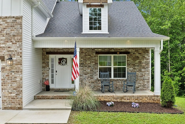 3650 Riggins Rd, Cumberland Furnace, TN 37051 - doorway to property with a porch, a shingled roof, and brick siding
