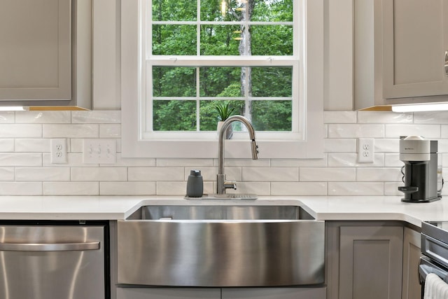 3650 Riggins Rd, Cumberland Furnace, TN 37051 - kitchen with dishwasher, a sink, gray cabinetry, light countertops, and decorative backsplash