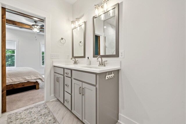 3650 Riggins Rd, Cumberland Furnace, TN 37051 - bathroom with double vanity, ceiling fan, baseboards, and connected bathroom