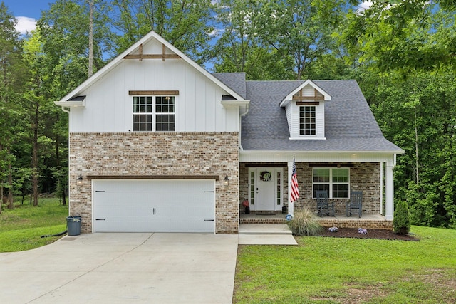 3650 Riggins Rd, Cumberland Furnace, TN 37051 - view of front of house featuring covered porch, a front yard, brick siding, an attached garage, and board and batten siding