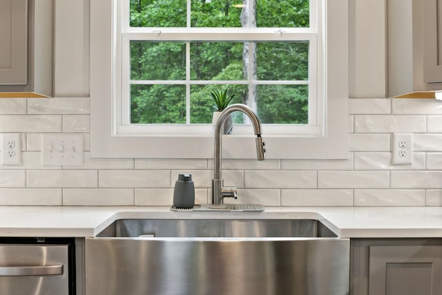 3650 Riggins Rd, Cumberland Furnace, TN 37051 - kitchen view of a sink, gray cabinetry, light countertops, and backsplash