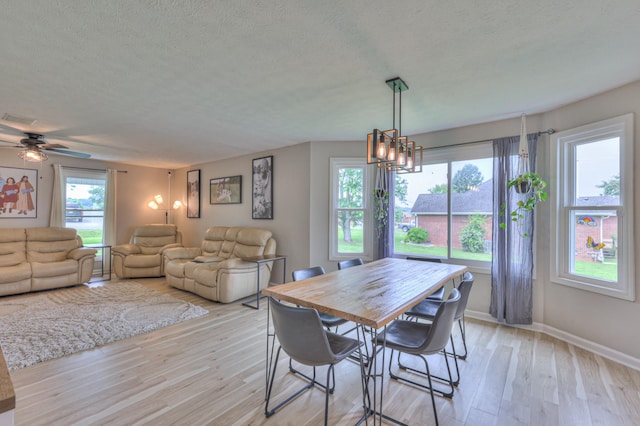 1713 Hollow Oak Dr, Lebanon, TN 37087 - dining room featuring light wood-style floors, a textured ceiling, baseboards, ceiling fan, and a chandelier