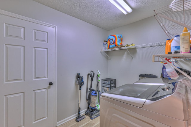 1713 Hollow Oak Dr, Lebanon, TN 37087 - laundry area with separate washer and dryer, a textured ceiling, light wood-style floors, and baseboards
