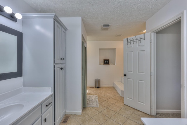1713 Hollow Oak Dr, Lebanon, TN 37087 - full bathroom featuring vanity, a textured ceiling, tile patterned floors, and baseboards