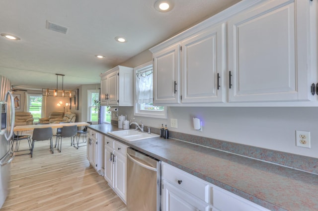 1713 Hollow Oak Dr, Lebanon, TN 37087 - kitchen with stainless steel appliances, a sink, white cabinetry, light wood-type flooring, and open floor plan
