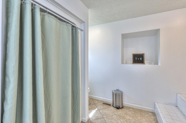 1713 Hollow Oak Dr, Lebanon, TN 37087 - full bath with toilet, tile patterned flooring, baseboards, and a textured ceiling