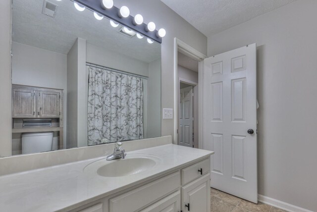 1713 Hollow Oak Dr, Lebanon, TN 37087 - bathroom with vanity, baseboards, and a textured ceiling
