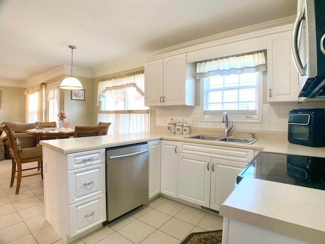 1635 Barrywood Cir E, Clarksville, TN 37042 - kitchen featuring appliances with stainless steel finishes, a peninsula, a sink, light tile patterned floors, and ornamental molding