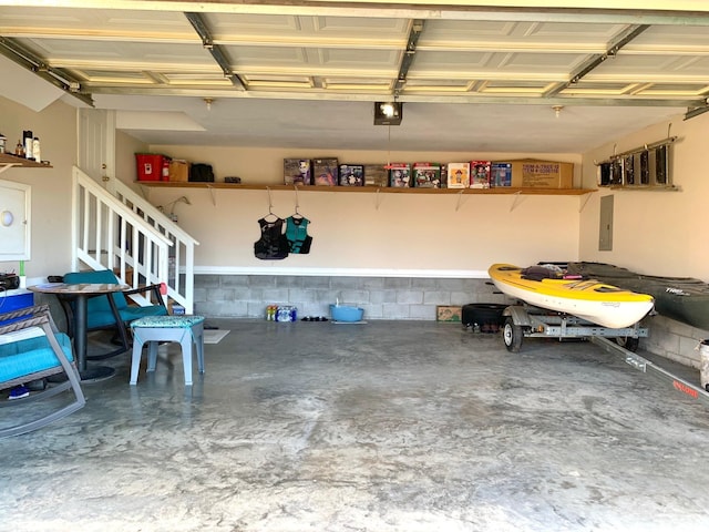 1635 Barrywood Cir E, Clarksville, TN 37042 - garage featuring a garage door opener, concrete block wall, and electric panel