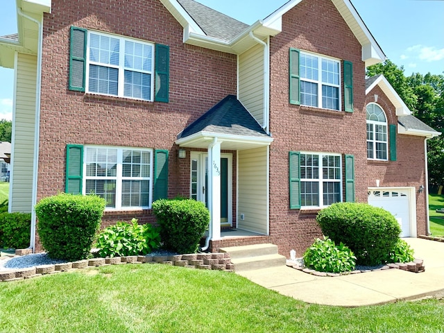1635 Barrywood Cir E, Clarksville, TN 37042 - view of front of property with a garage, a shingled roof, a front lawn, brick siding, and concrete driveway
