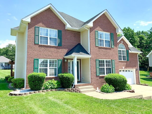 1635 Barrywood Cir E, Clarksville, TN 37042 - view of front of house featuring an attached garage, concrete driveway, a front yard, brick siding, and a shingled roof