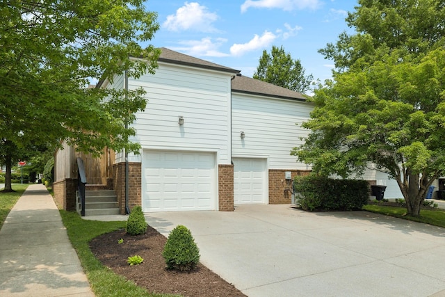 1332 Jewell Ave, Franklin, TN 37064 - view of home's exterior with brick siding, a garage, driveway, and a shingled roof