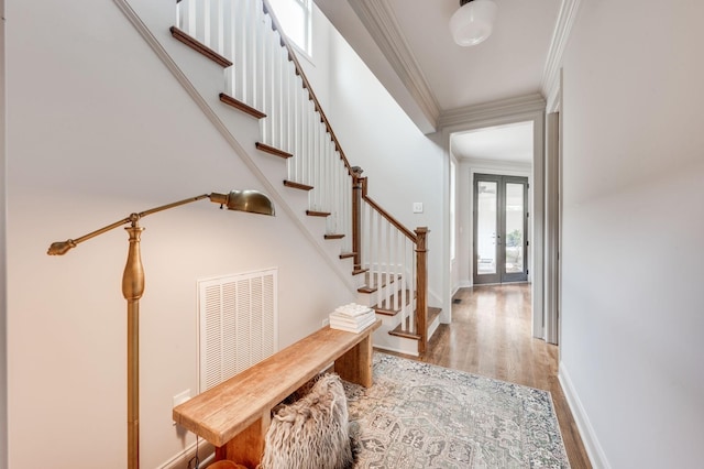 134 Fitzgerald St, Franklin, TN 37064 - foyer entrance featuring light wood-style floors, crown molding, stairway, baseboards, and french doors