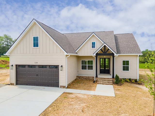 338 Dugout Rd, Summertown, TN 38483 - modern farmhouse style home with board and batten siding, driveway, and a shingled roof