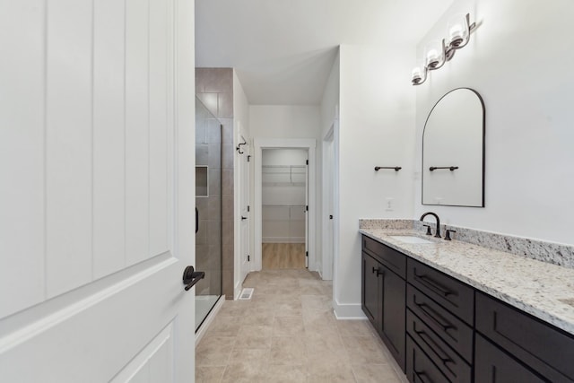 338 Dugout Rd, Summertown, TN 38483 - full bathroom featuring vanity, a shower stall, a spacious closet, and tile patterned flooring