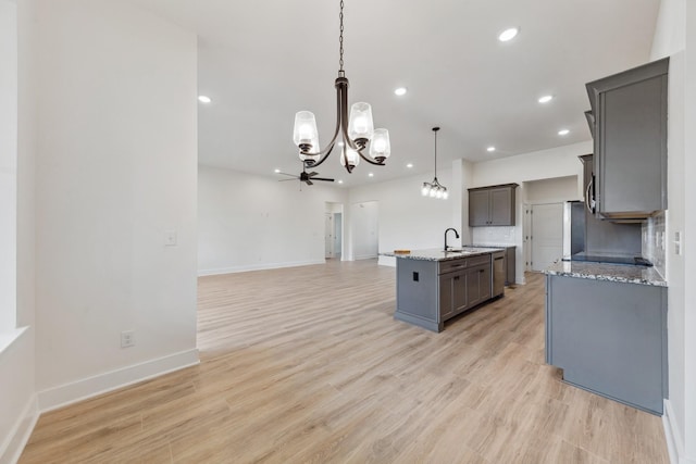 338 Dugout Rd, Summertown, TN 38483 - kitchen featuring a chandelier, a kitchen island with sink, gray cabinetry, open floor plan, and hanging light fixtures