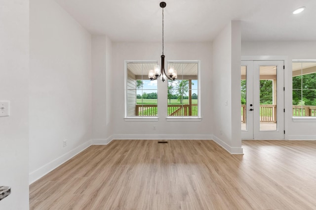 338 Dugout Rd, Summertown, TN 38483 - unfurnished dining area with light wood-style floors, healthy amount of natural light, and a chandelier