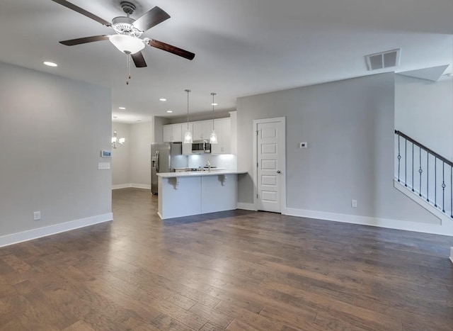 135 Grandstand Blvd, Gallatin, TN 37066 - unfurnished living room with ceiling fan, dark wood finished floors, baseboards, recessed lighting, and a chandelier