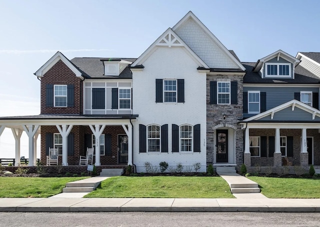 135 Grandstand Blvd, Gallatin, TN 37066 - view of front of home with a porch, brick siding, a front lawn, and stone siding