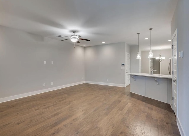 135 Grandstand Blvd, Gallatin, TN 37066 - unfurnished living room with recessed lighting, dark wood-style flooring, baseboards, ceiling fan, and a chandelier