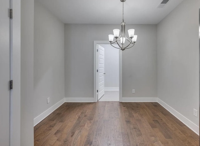 135 Grandstand Blvd, Gallatin, TN 37066 - spare room with a chandelier, wood finished floors, and baseboards