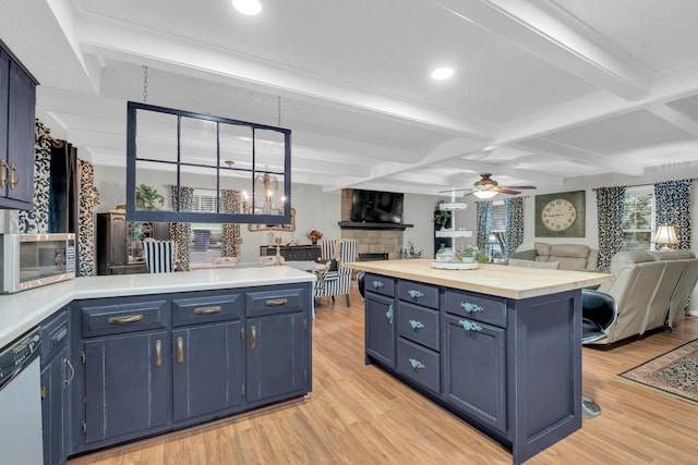 130 Shane Lee Cir, Dover, TN 37058 - kitchen with stainless steel microwave, blue cabinetry, dishwashing machine, light countertops, and light wood finished floors