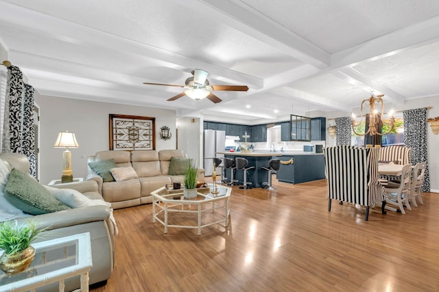 130 Shane Lee Cir, Dover, TN 37058 - living area featuring light wood-style floors, a chandelier, beamed ceiling, and ceiling fan