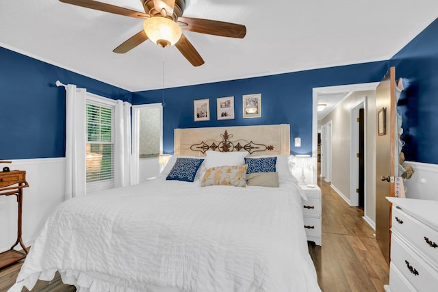 130 Shane Lee Cir, Dover, TN 37058 - bedroom with wood finished floors, a ceiling fan, and wainscoting