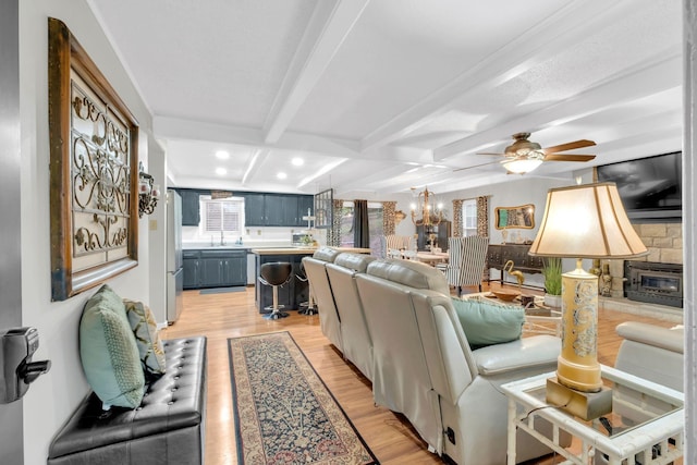130 Shane Lee Cir, Dover, TN 37058 - living room featuring light wood-style flooring, ceiling fan, beamed ceiling, coffered ceiling, and a fireplace