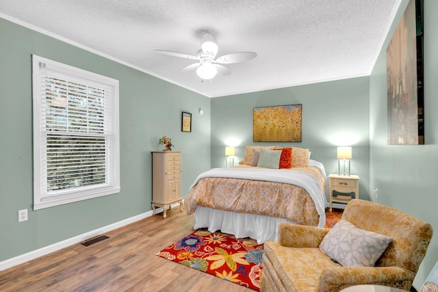 130 Shane Lee Cir, Dover, TN 37058 - bedroom featuring wood finished floors, a textured ceiling, crown molding, baseboards, and ceiling fan