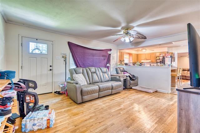 413 Colonial Ter, Hopkinsville, KY 42240 - living area with ornamental molding, ceiling fan, and light wood-style flooring