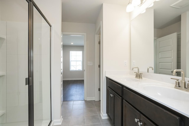 5046 Dayflower Dr, Hermitage, TN 37076 - bathroom with double vanity, a stall shower, tile patterned floors, and baseboards