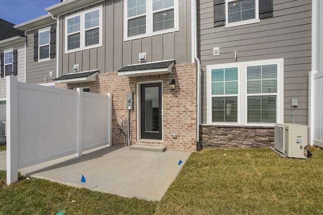 5046 Dayflower Dr, Hermitage, TN 37076 - property entrance with ac unit, a patio area, board and batten siding, and brick siding