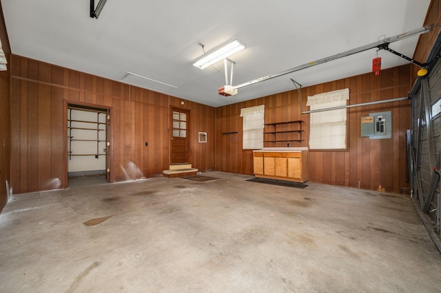2715 Clearview Ct, Murfreesboro, TN 37129 - garage featuring wood walls, a garage door opener, and electric panel