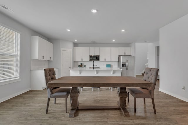 129 Southwind Run, Spring Hill, TN 37174 - dining room with recessed lighting, light wood finished floors, and stairway