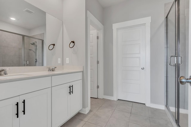 129 Southwind Run, Spring Hill, TN 37174 - full bathroom featuring a stall shower, double vanity, and tile patterned flooring