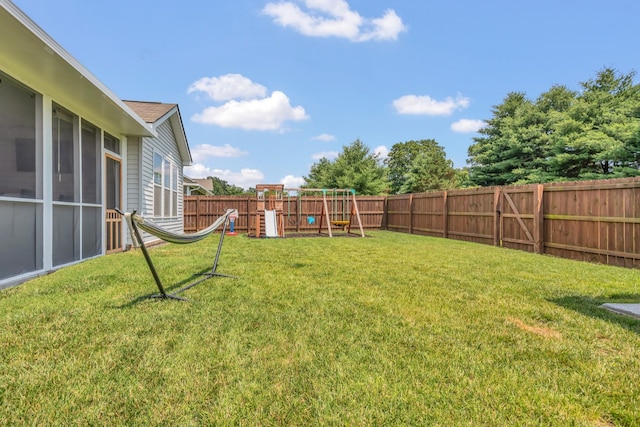 129 Southwind Run, Spring Hill, TN 37174 - fenced backyard featuring a playground and a sunroom