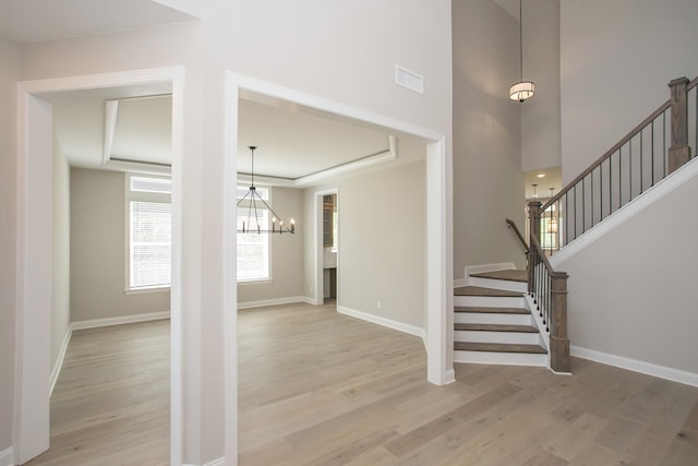 5956 Hunt Valley Dr, Spring Hill, TN 37174 - foyer entrance with a chandelier, light wood-style floors, stairway, baseboards, and a towering ceiling